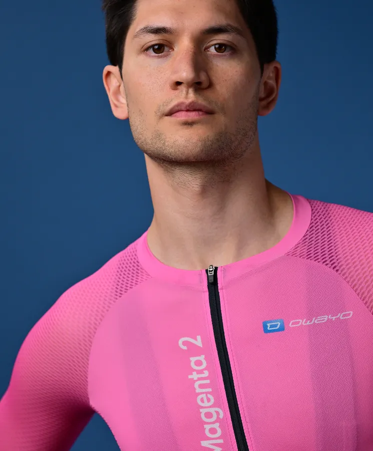 A man wears a pink, sleeveless athletic top with a zipper and the 'owayo' logo on the chest.